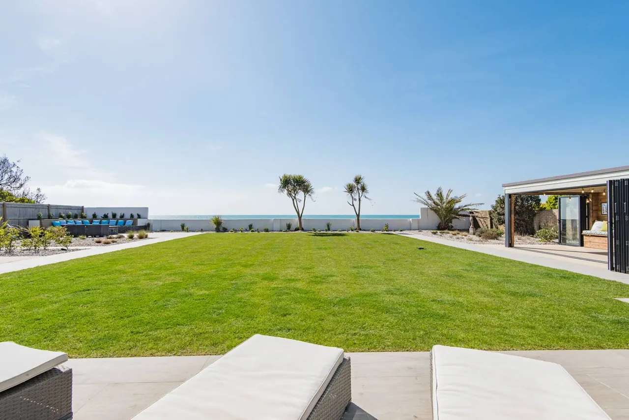 The lawn running down to the sea
