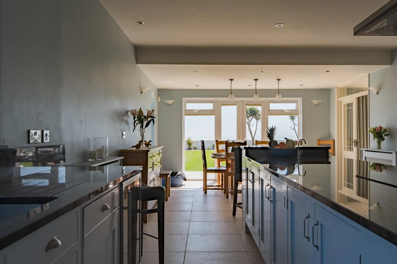 The long kitchen at Sun Beach House, with the sea through the windows