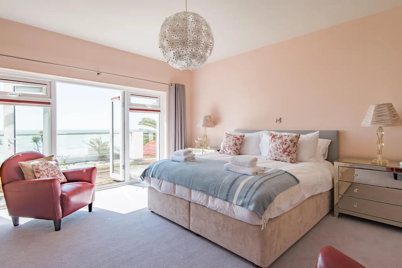 A sea-view bedroom with French doors to the balcony